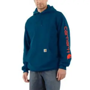 A man wearing a blue hoodie with red lettering.