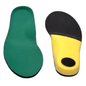 A pair of shoes with different colored soles.