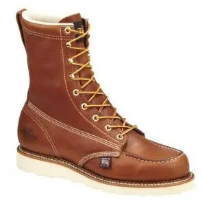 A brown work boot with white sole and tan laces.